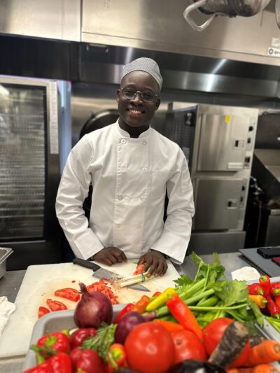 A young smiling chef in the kitchen
