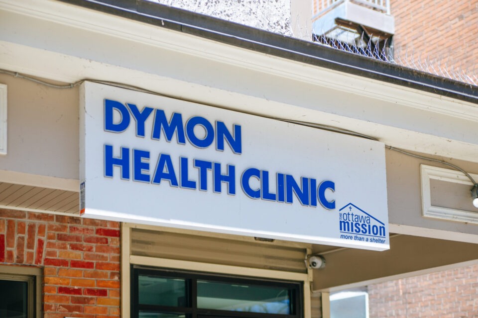 A red brick building with a sign that reads: DYMON HEALTH CLINIC